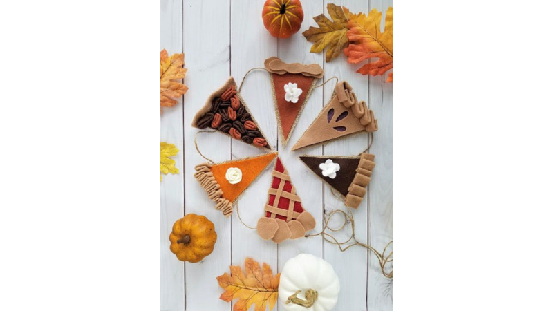 Variety of pie slices made of felt and strung together in a garland