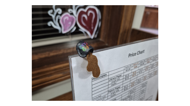 mini mug of spilled coffee made of air dry clay and painted with the coffey county library logo